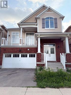 Kitchener apartment for rent - A two-story house with a white garage door and a red brick exterior.