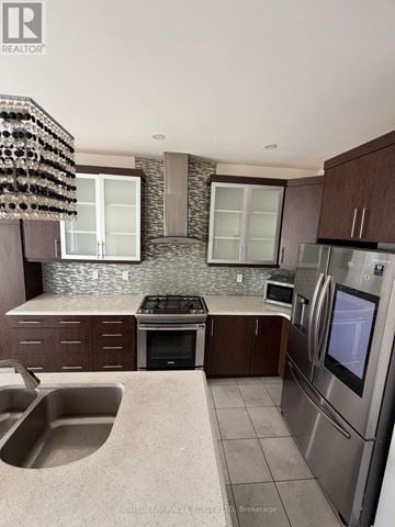 Kitchener apartment for rent - A modern kitchen with a stainless steel refrigerator and a stone backsplash.