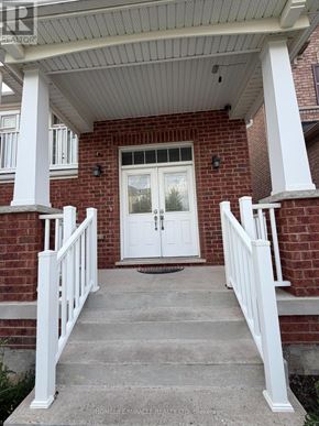 Kitchener apartment for rent - A white door is on the front of a brick house.
