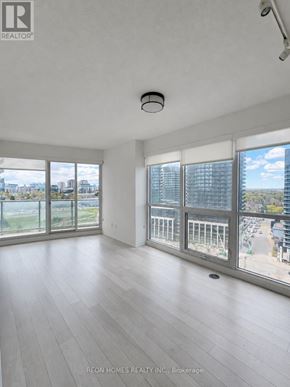 Toronto (Bayview Village) condo for rent - A spacious room with large windows and a view of the city.