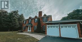 Caledon apartment for rent - A red brick house with a white garage door.