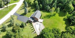 Caledon apartment for rent - A bird's eye view of a house surrounded by trees.