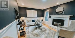 Caledon apartment for rent - A living room with a fireplace and a mirror on the wall.