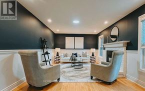 Caledon apartment for rent - A living room with two grey chairs and a fireplace.