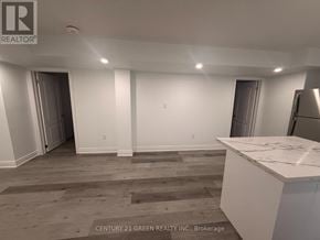Milton (Cb Cobban) apartment for rent - A room with a white counter and wooden floors.