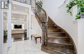Brampton (Northwest Brampton) apartment for rent - A wooden staircase with a metal railing leads to a second floor.
