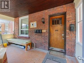 Toronto (Dovercourt-Wallace Emerson-Junction) apartment for rent - A wooden door is on the brick wall of a room.