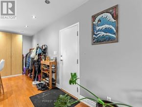 Toronto (Dovercourt-Wallace Emerson-Junction) apartment for rent - A room with a painting of a wave on the wall and a black mat on the floor.