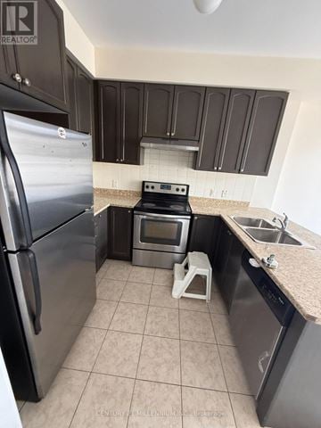 Brampton (Heart Lake East) townhouse for rent - A kitchen with a stainless steel refrigerator, microwave, and dishwasher.