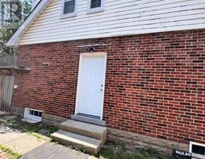 Burlington (Lasalle) apartment for rent - A red brick house with a white door and a small window above it.