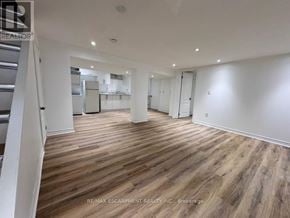 Burlington (Lasalle) apartment for rent - A spacious room with wooden flooring and white walls.