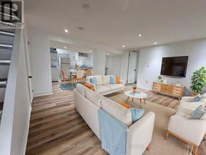 Burlington (Lasalle) apartment for rent - A living room with a white couch and a television on the wall.