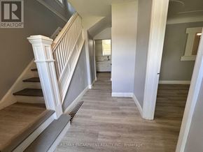 Burlington (Lasalle) apartment for rent - A hallway with a staircase on the left and a doorway on the right.