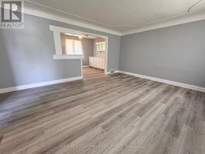 Burlington (Lasalle) apartment for rent - A room with wooden flooring and a window with curtains.