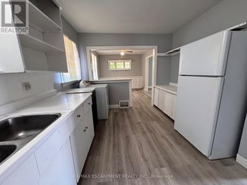 Burlington (Lasalle) apartment for rent - A kitchen with white cabinets and a wooden floor.