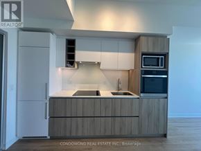 Toronto (Moss Park) condo for rent - A kitchen with a sink, stove, and refrigerator.