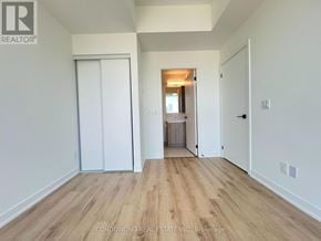 Toronto (Moss Park) condo for rent - A room with a white door and a wooden floor.