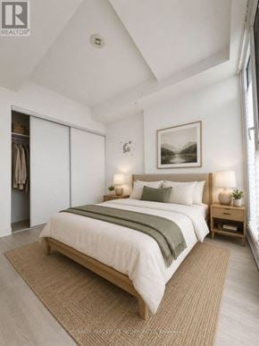 Mississauga (City Centre) condo for rent - A bedroom with a large bed and a painting on the wall.