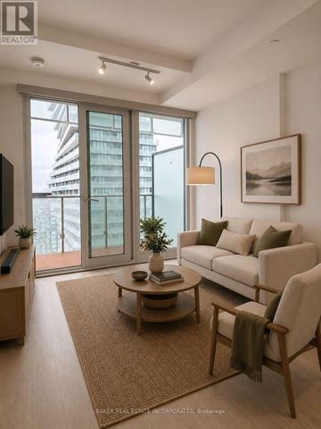 Mississauga (City Centre) condo for rent - A living room with a couch, chair, and a table with a plant on it.