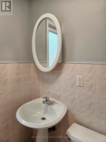 Toronto (Downsview-Roding-Cfb) apartment for rent - A bathroom with a sink, toilet and mirror.