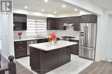 Milton (Cb Cobban) townhouse for rent - A modern kitchen with dark brown cabinets and stainless steel appliances.
