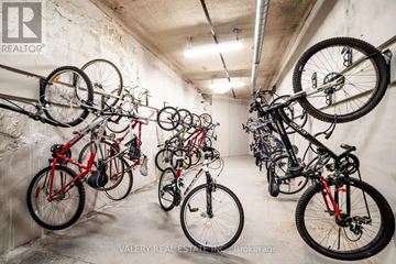 Oshawa (Samac) condo for rent - A row of bicycles are parked in a garage.