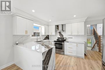 Vaughan (East Woodbridge) apartment for rent - A modern kitchen with white cabinets and a marble island.