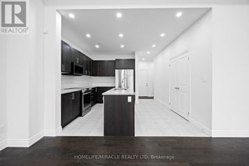 Cambridge apartment for rent - A modern kitchen with black cabinets and a central island.