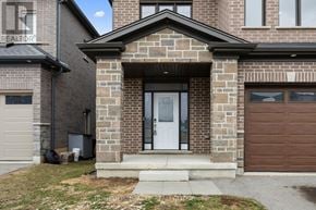 Cambridge apartment for rent - A brick house with a white door and a garage door.