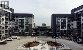 Oakville condo for rent - A large building complex with a circular courtyard in the middle.