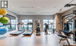Oakville condo for rent - A gym with a variety of equipment including treadmills, exercise bikes, and weight machines.