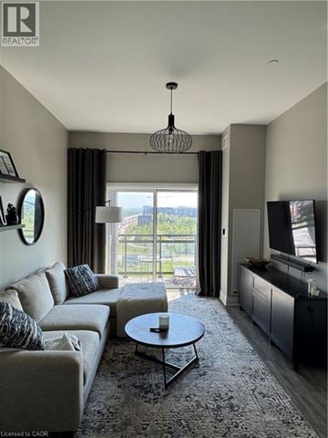 Oakville condo for rent - A living room with a grey sofa and a round coffee table.