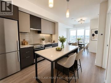 Toronto (Kensington-Chinatown) condo for rent - A modern kitchen with a dining table and chairs.