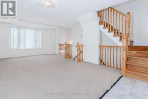 Mississauga (Churchill Meadows) townhouse for rent - A spacious room with a staircase and a carpeted floor.