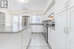 Mississauga (Churchill Meadows) townhouse for rent - A white kitchen with a granite counter top and stainless steel appliances.
