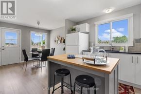 Ottawa condo for rent - A kitchen with a table and chairs in front of a window.