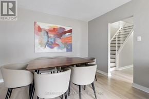Ottawa condo for rent - A dining room with a wooden table and chairs.