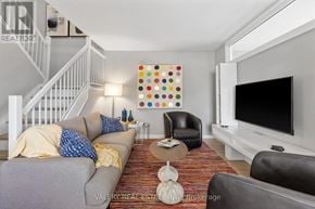 Ottawa condo for rent - A living room with a grey couch and a white television.