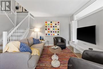 Ottawa condo for rent - A living room with a grey couch and a white television.