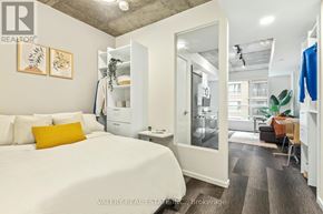 Ottawa condo for rent - A bedroom with a bed, a desk, and a chair.