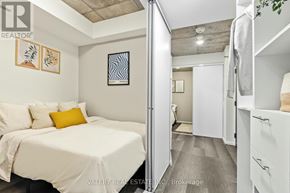 Ottawa condo for rent - A bedroom with a bed, a nightstand, and a closet.