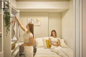 Ottawa condo for rent - A woman is hanging a towel on a rack in a room.