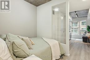 Ottawa condo for rent - A bedroom with a bed, pillows, and a window.