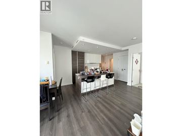 Burnaby apartment for rent - A modern dining room with a wooden floor and a glass table.