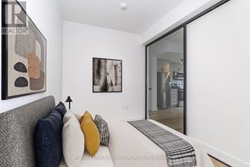 Toronto (Dovercourt-Wallace Emerson-Junction) condo for rent - A living room with a grey couch and a painting on the wall.