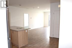 Guelph (Willow West/Sugarbush/West Acres) condo for rent - A real estate company is showcasing an empty apartment.