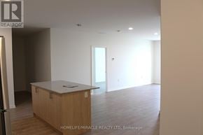Guelph (Willow West/Sugarbush/West Acres) condo for rent - A spacious room with a counter and cabinets.