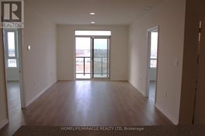 Guelph (Willow West/Sugarbush/West Acres) condo for rent - A spacious room with wooden floors and a large window.