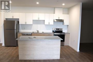 Guelph (Willow West/Sugarbush/West Acres) condo for rent - A modern kitchen with a refrigerator, stove, and cabinets.