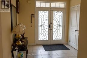 Brampton (Northwest Brampton) apartment for rent - A white door with a glass panel and metal grill design.